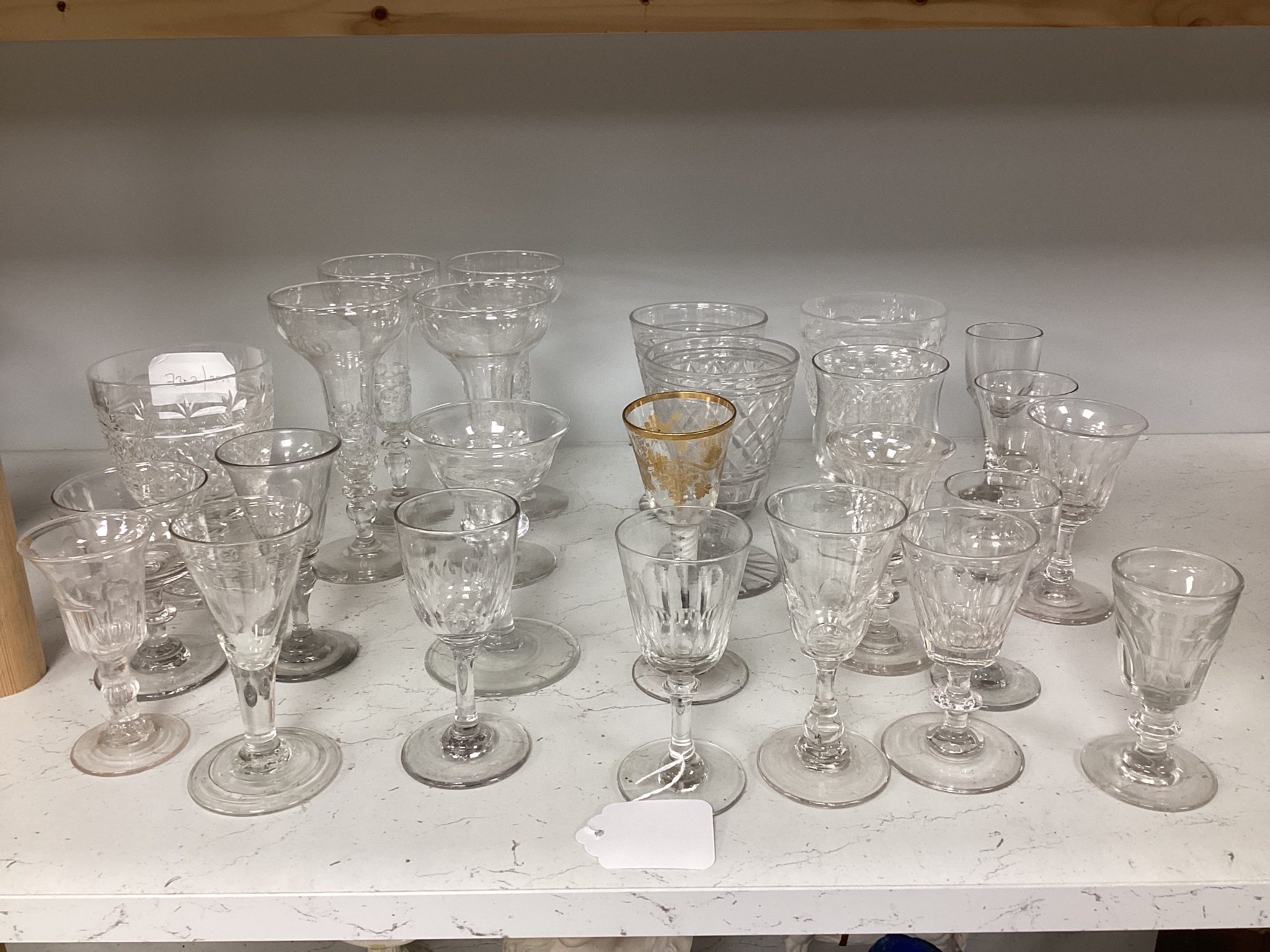 A quantity of assorted 18th / 19th century and later clear drinking glasses including a damaged James Giles gilt decorated opaque twist stem wine glass.